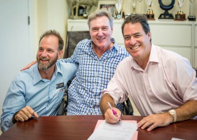 Dr. Yaron Rado signing the agreement on behalf of Doctors Hospital and Kim Lund and James Bovell, BCF Board Directors.